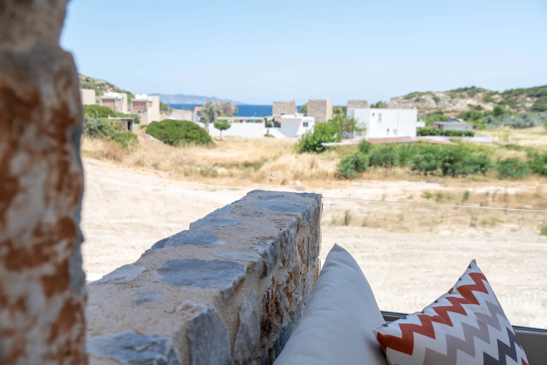 Sea view over a stone ledge from a suite terrace